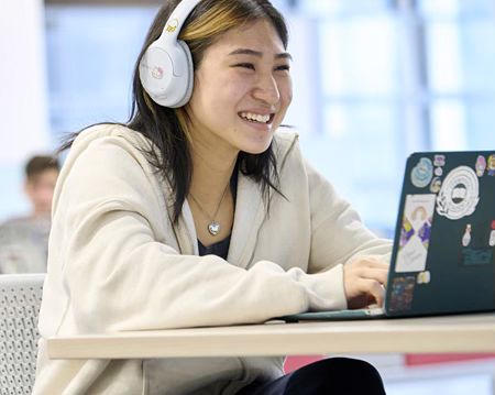 Student working on a laptop in a modern learning environment